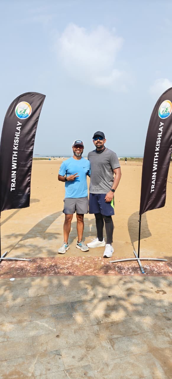 Athlete standing with Coach Kishlay at the Goa camp